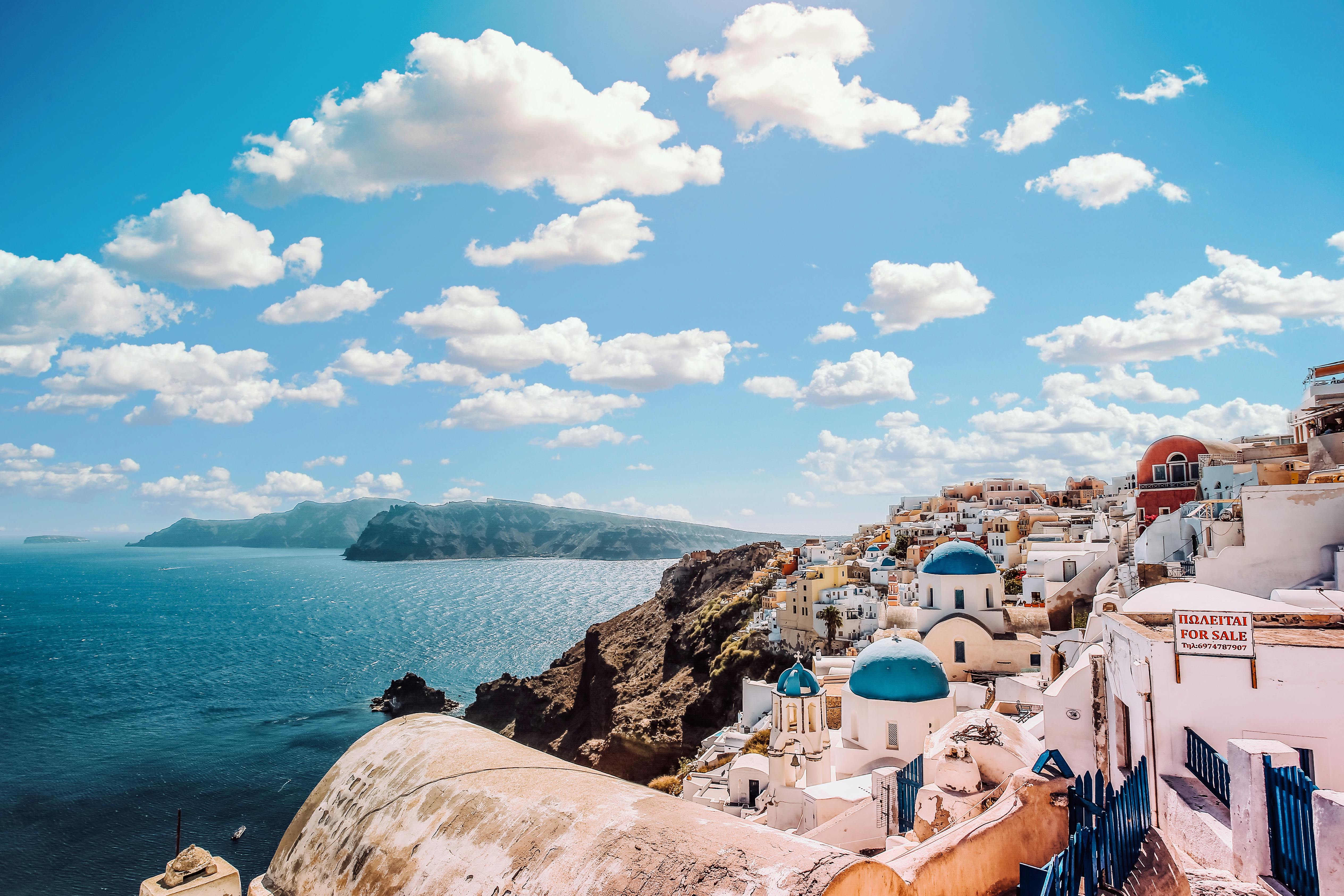 Santorini Greece with white buildings and blue domes overlooking the sea